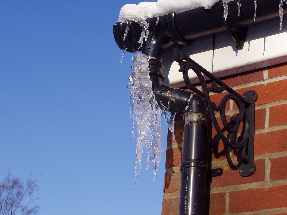 Rain drain being cleaned in the winter