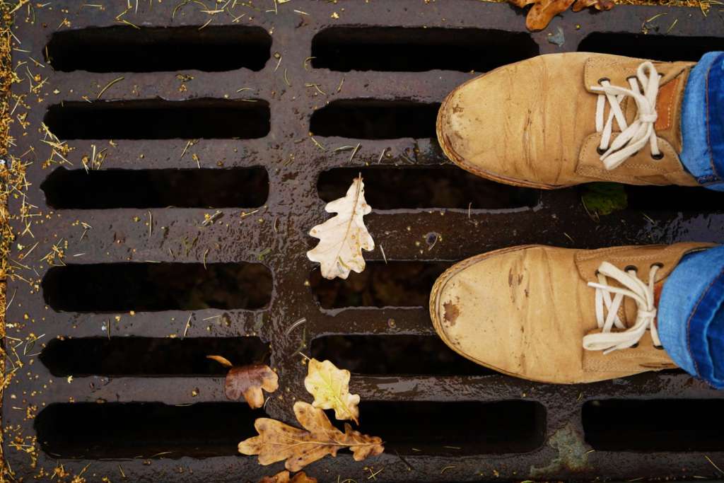 Best draincleaners in portland standing over sewer grate